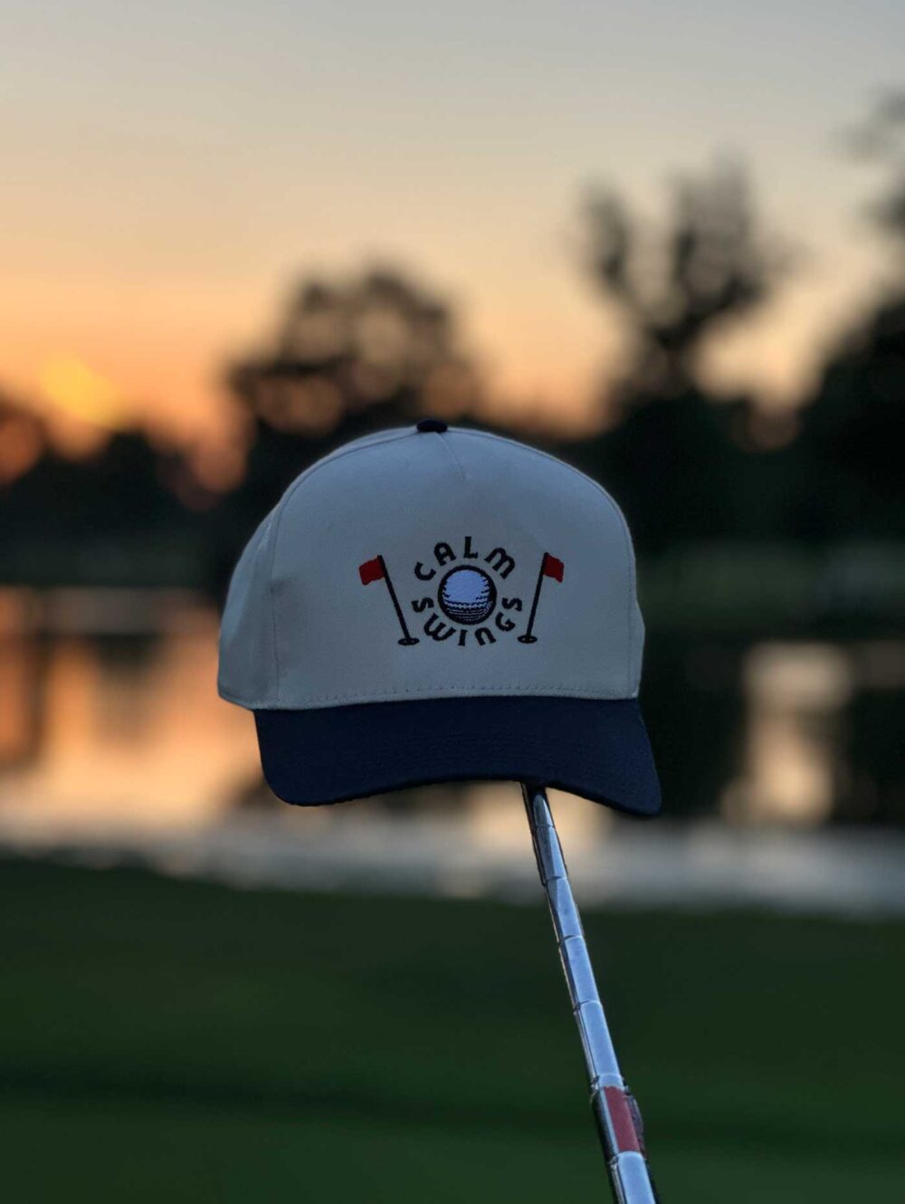 Tradition golf hat on putter